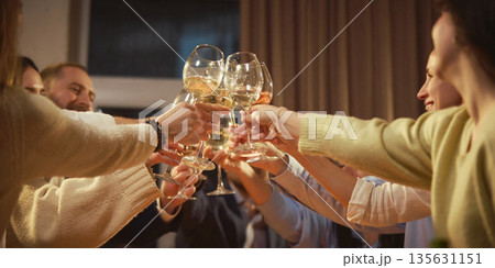 Close up of friends clinking wine glasses together. Close up of friends clinking wine glasses together. 135631151