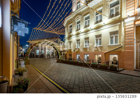 Charming night exterior of a historic hostel on a festively lit street 135631289