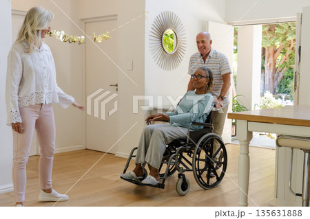 Senior friends enjoying time together at home, smiling and sharing joyful moments 135631888