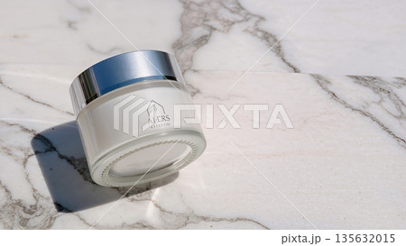 Face cream moisturiser, glass jar on marble stone background, skincare and cosmetic, beauty product concept 135632015