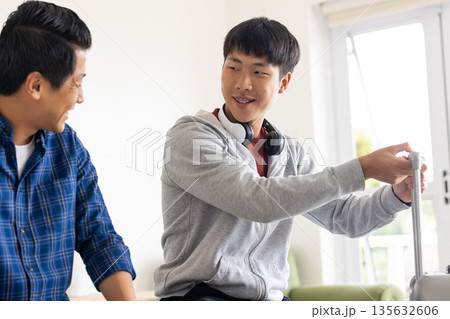 Father and son bonding at home, smiling and enjoying quality time together 135632606