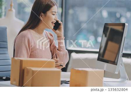Starting small businesses SME owners female entrepreneurs check online orders to prepare to pack the boxes, sell to customers, sme business ideas online. Starting small businesses SME owners female entrepreneurs check online orders to prepare to pack the boxes, sell to customers, sme business ideas online. 135632804