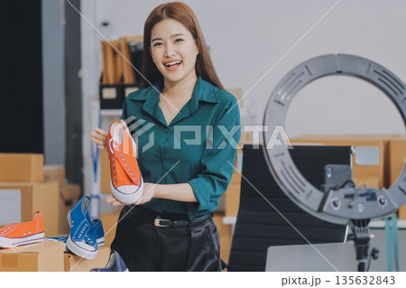 Starting small businesses SME owners female entrepreneurs check online orders to prepare to pack the boxes, sell to customers, sme business ideas online. Starting small businesses SME owners female entrepreneurs check online orders to prepare to pack the boxes, sell to customers, sme business ideas online. 135632843