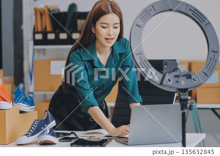 Starting small businesses SME owners female entrepreneurs check online orders to prepare to pack the boxes, sell to customers, sme business ideas online. 135632845