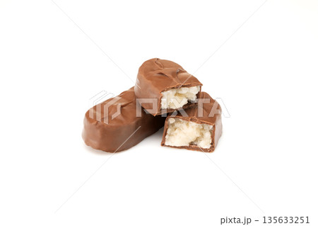 A chocolate bar with a white filling is cut in half 135633251