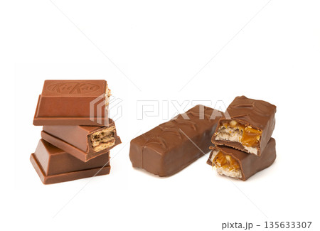 A stack of Kit Kats and a half eaten Kit Kat bar 135633307