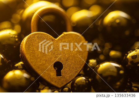 A golden heart with a keyhole in the middle A golden heart with a keyhole in the middle 135633436