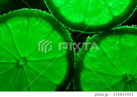 Three green lime slices are shown in a close up Three green lime slices are shown in a close up 135633451
