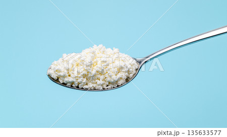 A spoonful of white powder is shown on a blue background A spoonful of white powder is shown on a blue background 135633577