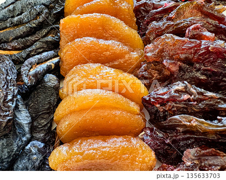 A plate of dried fruit with a variety of colors and shapes 135633703