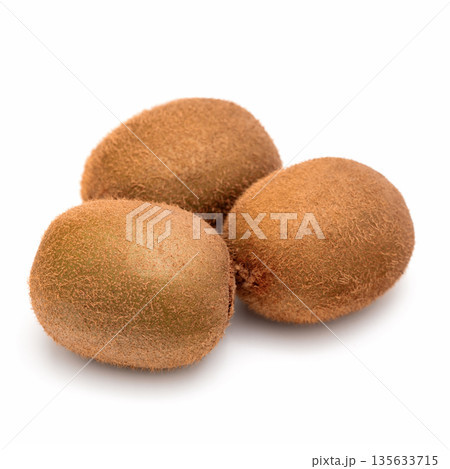 Three kiwi fruits are sitting on a white background 135633715