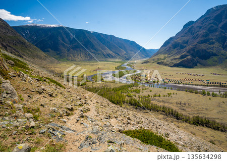 Chulyshman river winding through vast valley in Altai Russia seen from viewpoint near stone mushrooms Breathtaking Siberian landscape of mountains and flowing water Chulyshman river winding through vast valley in Altai Russia seen from viewpoint near stone mushrooms Breathtaking Siberian landscape of mountains and flowing water 135634298