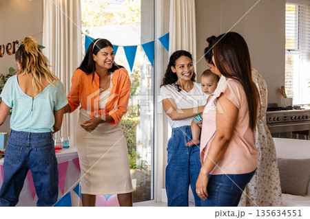 Women enjoying lively conversation at home during festive family gathering 135634551