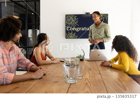 Celebrating success, business team smiling and discussing achievements in conference room Celebrating success, business team smiling and discussing achievements in conference room 135635317