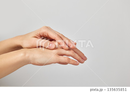 Female hands gently touching, symbolizing skin hydration, care, and wellness on a white background Female hands gently touching, symbolizing skin hydration, care, and wellness on a white background 135635851