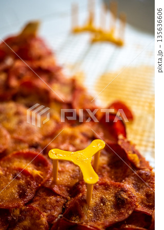 Pepperoni Pizza Slice with Yellow Pizza Saver 135636606