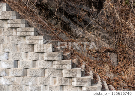 Geometric Stone Retaining Wall on Rocky Hillside Geometric Stone Retaining Wall on Rocky Hillside 135636740