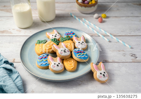Easter cookies with bottles of milk on white wooden background. Spring holidays background 135638275