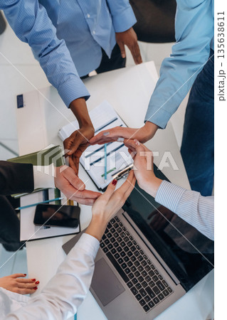 Making circle gesture by hands. Top view of hands of business people that are celebrating success 135638611