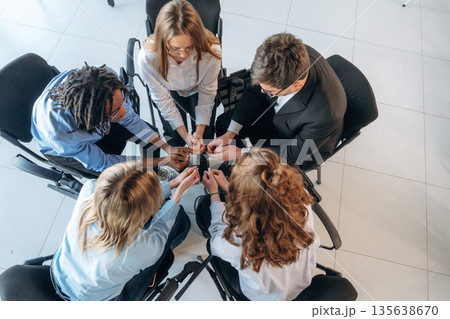 View from the top, closeness. People are in group psychological support room together View from the top, closeness. People are in group psychological support room together 135638670
