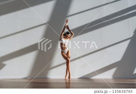 In sportive underwear. Beautiful young woman with slim body type is indoors In sportive underwear. Beautiful young woman with slim body type is indoors 135638793