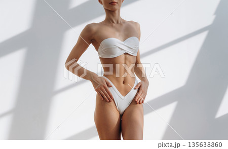 New bikini, standing and showing. Close up view of woman with slim body type indoors 135638860