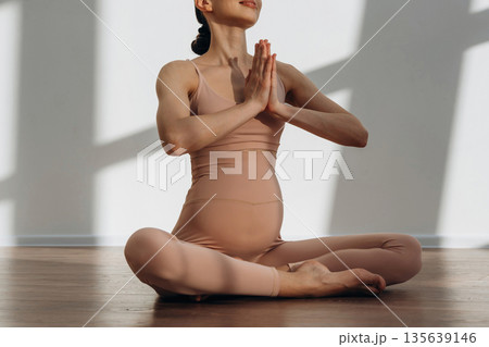 Expecting a child. Pregnant woman is indoors Expecting a child. Pregnant woman is indoors 135639146