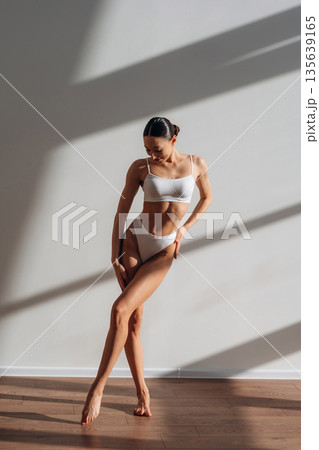 Demonstrating her body. Beautiful young woman is indoors 135639165
