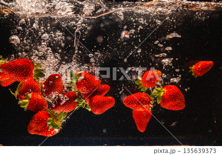 Fresh Strawberries Splashing in Water Fresh Strawberries Splashing in Water 135639373
