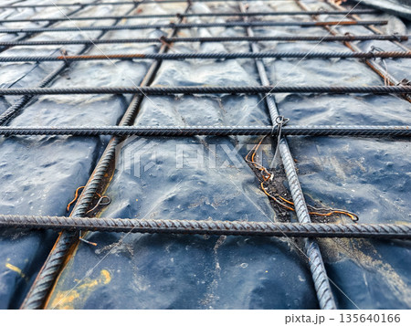 Close-up of rebar grid on construction site. Close-up of rebar grid on construction site. 135640166