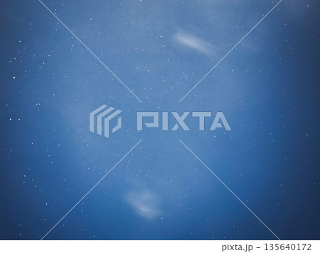 Starry night sky with subtle clouds and a tranquil ambiance. 135640172