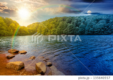 beautiful view of landscape with lake. day and night time change concept. body of water among beech forest in mountains with sun and moon at twilight. harmony and progress calendar beautiful view of landscape with lake. day and night time change concept. body of water among beech forest in mountains with sun and moon at twilight. harmony and progress calendar 135640557