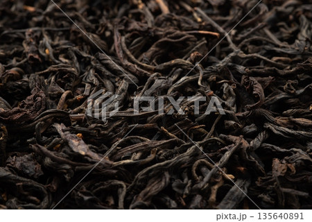 Pile of black tea on white background. Pile of black tea on white background. 135640891