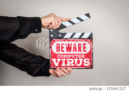 BEWARE COMPUTER VIRUS Cybersecurity Warning Sign Held With Film Clapper 135641127