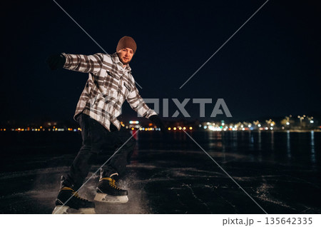 Leisure activities, riding. A man is on the ice with his skates in winter 135642335