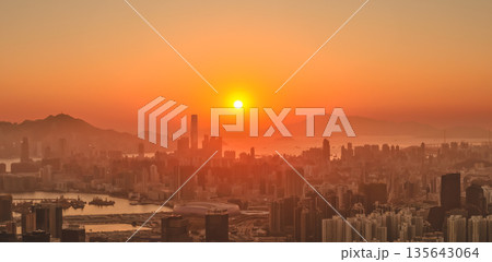 Jan 11 2026 Golden sunset illuminating Hong Kong vibrant Kowloon Peninsula skyline 135643064