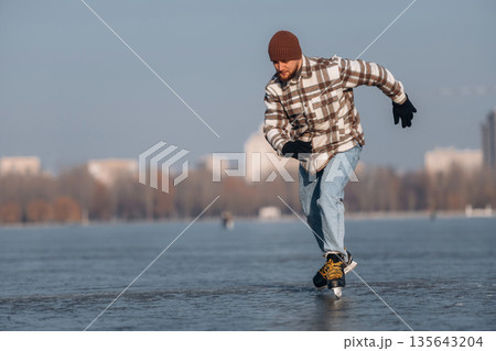 In motion, riding. A man is on the ice with his skates in winter 135643204