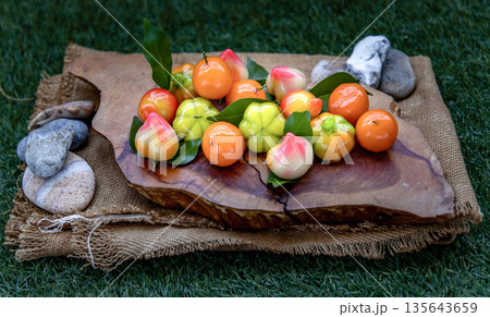 Kanom Look Choup : An old traditional thai dessert made from green been, coconut milk, sugar and jelly, Deletable imitation fruits made from green been, coconut milk, sugar and jelly in fruit shape on 135643659