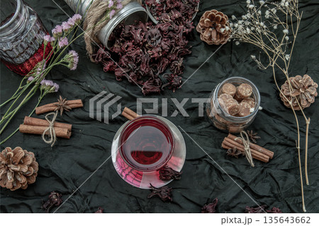 Roselle tea (Jamaica sorrel, Rozelle or hibiscus sabdariffa ) with dry roselle and brown cane sugar cube. 135643662