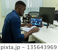 Black Researcher Making a Quantum Computing Experiment 135643969