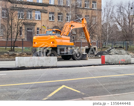 Road repair work.Excavator bulldozer move shoveling bucket Road repair work.Excavator bulldozer move shoveling bucket 135644448