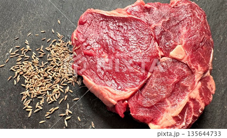 Chef Preparing Flavorful Ribeye With Cumin Seeds On Slate Background, Vivid Image Of Spiceenhanced Ribeye Steak Showcasing Marbling And Rustic Aesthetic For Culinary Visuals 135644733