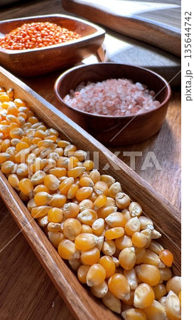 Detailed Food Scene, Vivid Depiction Of Grains And Spices Under Warm Morning Illumination, An Intimate View Of Textured Corn And Lentils Illuminated By Gentle Morning Light 135644742