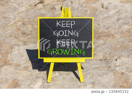 Keep going and growing symbol. Concept words phrase Keep going keep growing on beautiful black blackboard. Beautiful stone background. Business Keep going and growing concept. Copy space. Keep going and growing symbol. Concept words phrase Keep going keep growing on beautiful black blackboard. Beautiful stone background. Business Keep going and growing concept. Copy space. 135645152