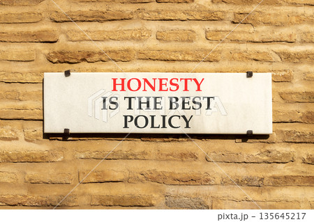 Honesty is the best policy symbol. Concept words Honesty is the best policy on beautiful white marble sign plate. Beautiful brick wall background. Business honesty is best policy concept. Copy space. Honesty is the best policy symbol. Concept words Honesty is the best policy on beautiful white marble sign plate. Beautiful brick wall background. Business honesty is best policy concept. Copy space. 135645217