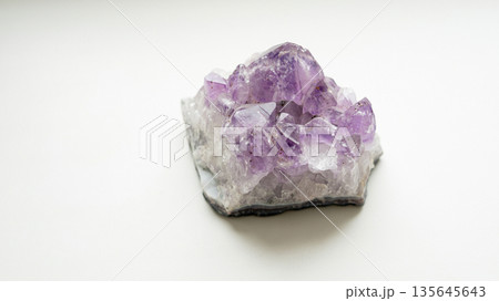 Amethyst crystal cluster on white background with purple and clear gemstones Amethyst crystal cluster on white background with purple and clear gemstones 135645643