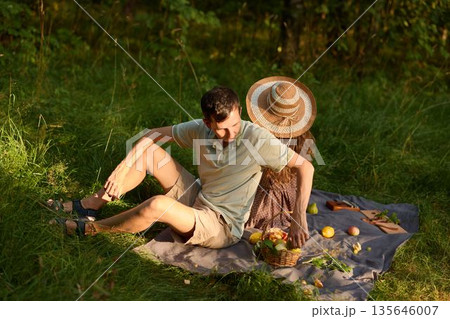 Serene couple sharing casual conversation outdoors during daylight 135646007