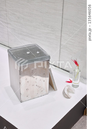 Sophisticated wash area featuring sleek fixtures and decorative accents 135646056