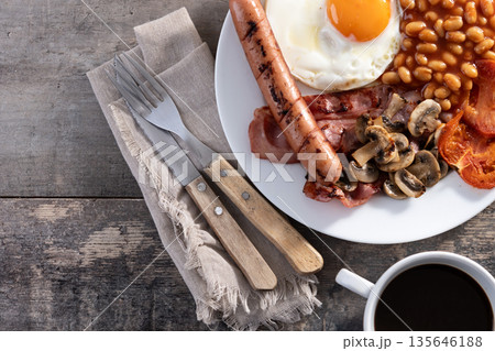 Full English breakfast with fried egg, bacon, sausages and beans Full English breakfast with fried egg, bacon, sausages and beans 135646188