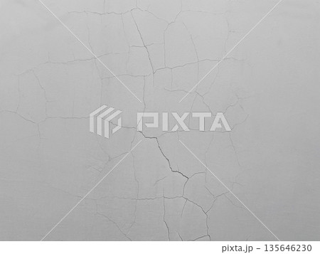縦や斜めにひび割れが入った暗い白灰色のコンクリート壁の横長の背景画像 135646230